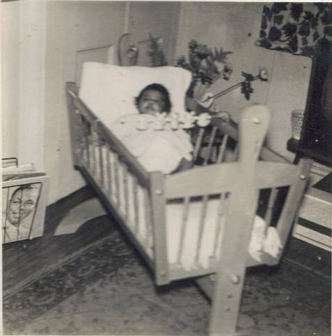 Me as a baby in a cot with the Nat King Cole Album